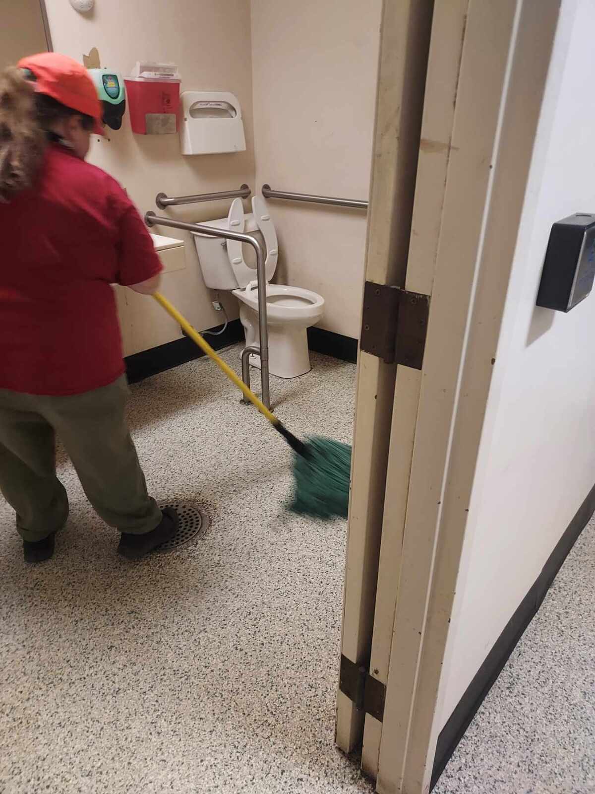 a woman mopping a bathroom floor